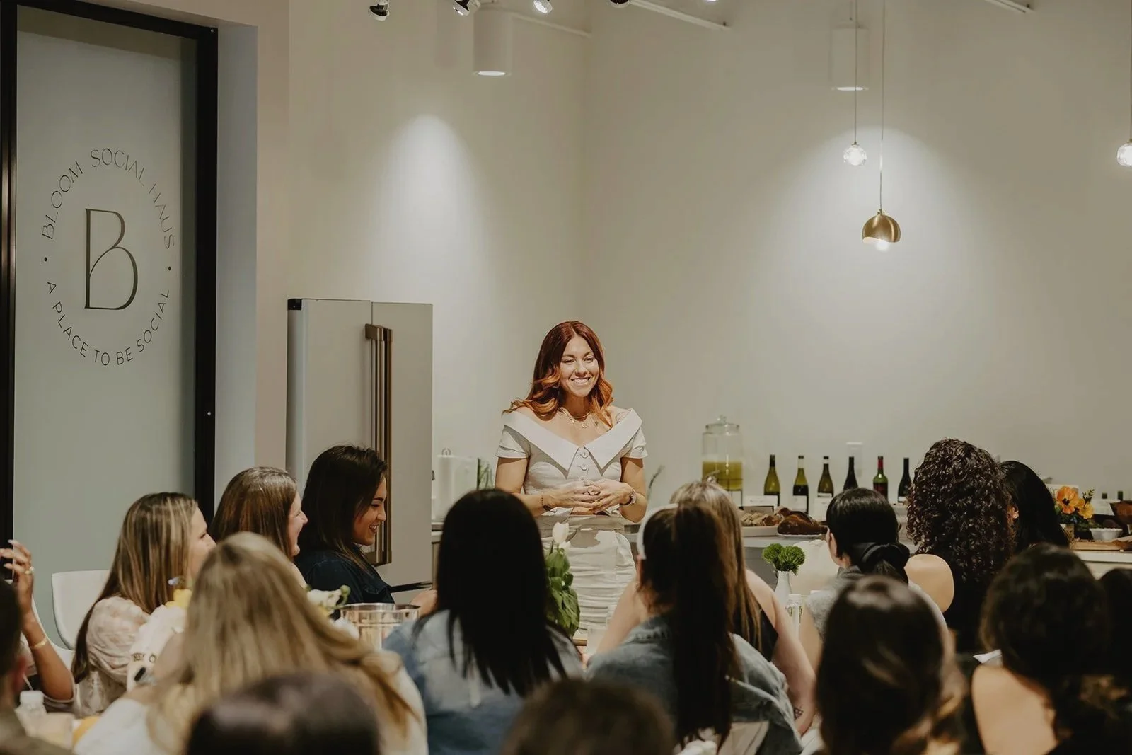 Alison Thacker, Founder of TheCheekyClean, stands in front of a group of women to present her masterclass: TheCheekyClean Lifestyle Detox Course.