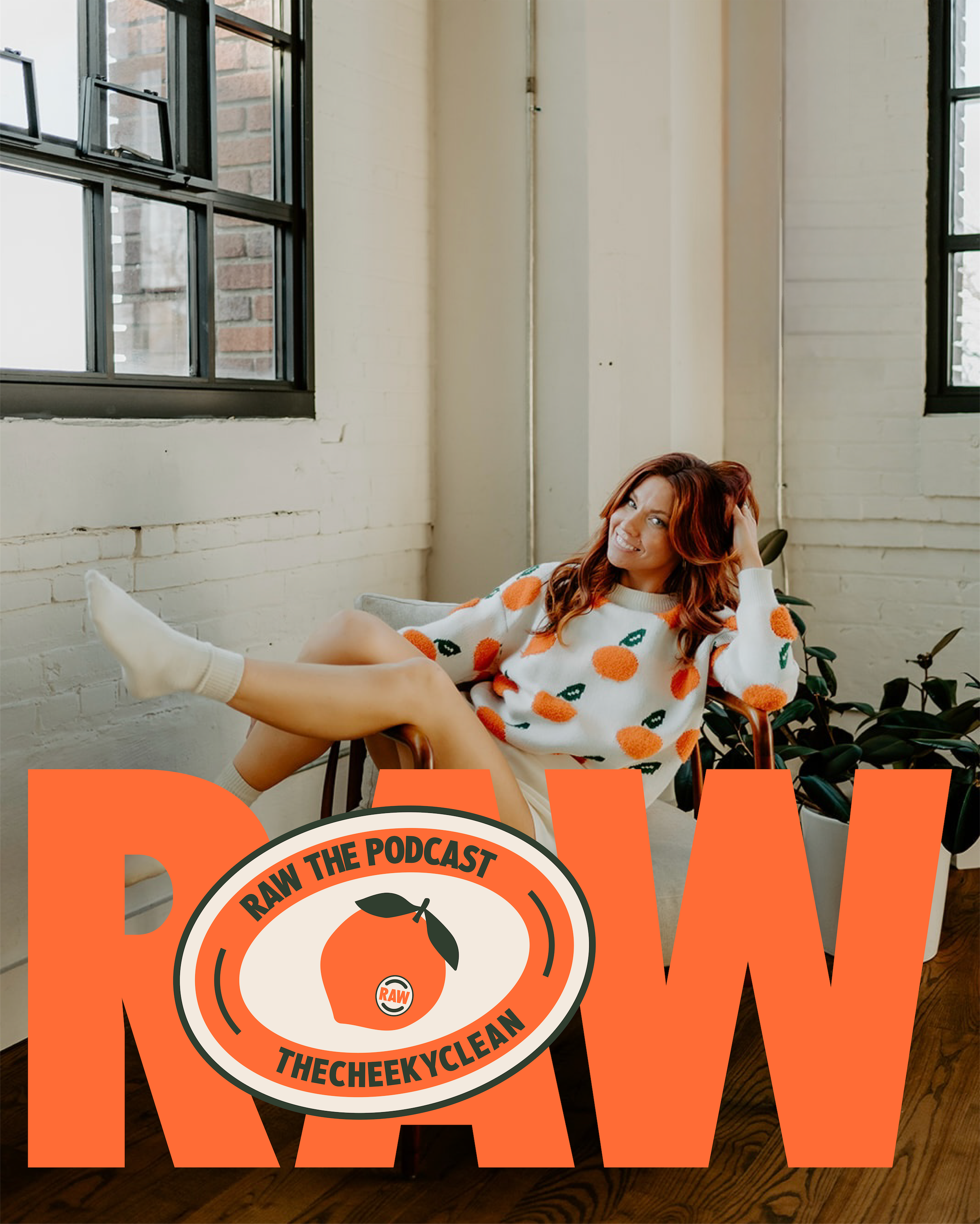 A young woman with red hair and a cheerful expression, wearing a white sweater with orange and green fruit patterns, sits on a chair in a bright room with white brick walls and large black-framed windows, with a logo for the "Raw the Podcast" overlayed at the bottom.