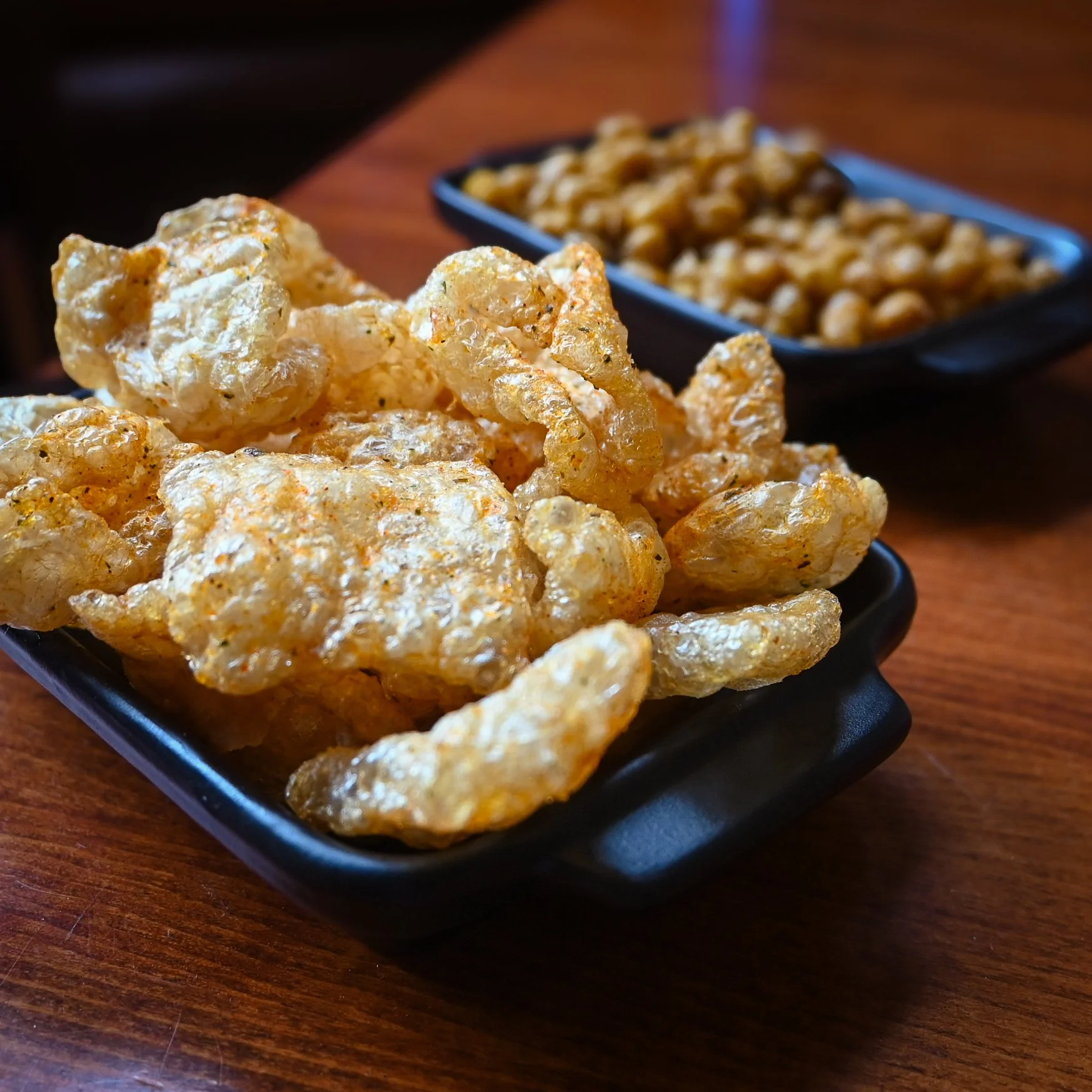 Freshly popped seasoned Pork Rinds and Crispy Chickpea bar snacks