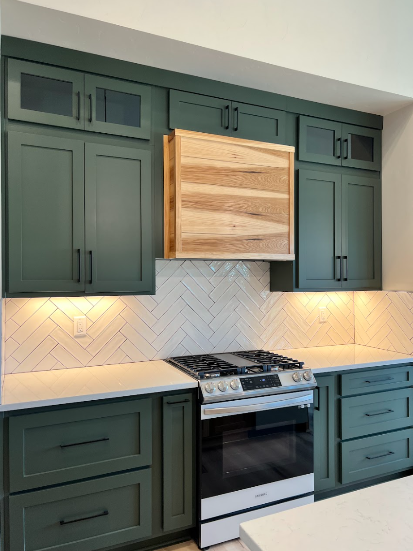 Foxhall green kitchen with hickory island and herring bone white subway tile.png