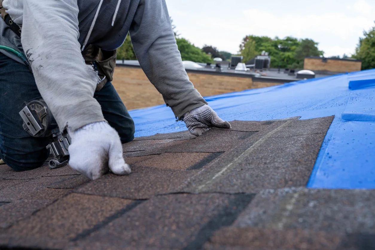 Man Fixing Shingles Roof