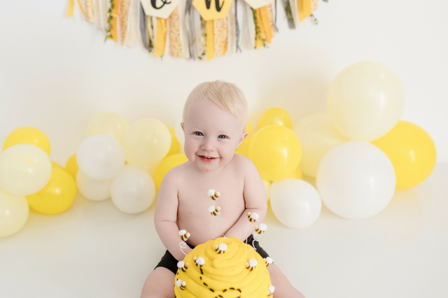 Charlie is one! Parents love cake smash sessions because the pressure is off for the kid to smile and pose. You just set the cake down in front of them and let them eat!