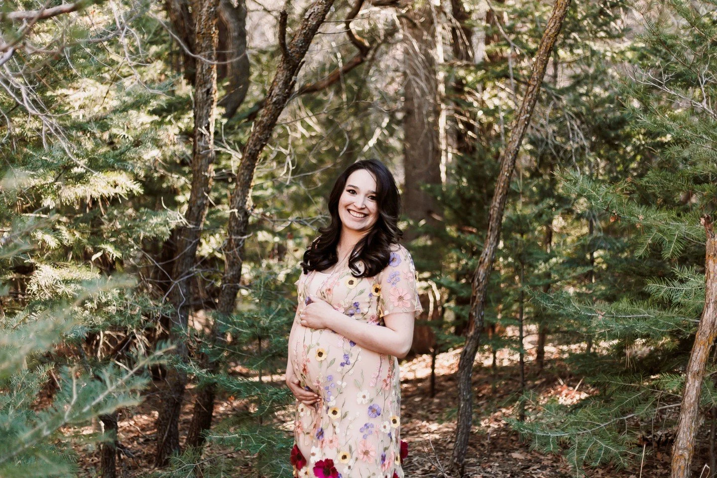 Some afternoons in the mountains feel almost magical, and this maternity session at Doc Long Picnic Area was one of those afternoons.

The soft light, the tall pines, and her beautiful dress embroidered with delicate flowers made the whole session fe