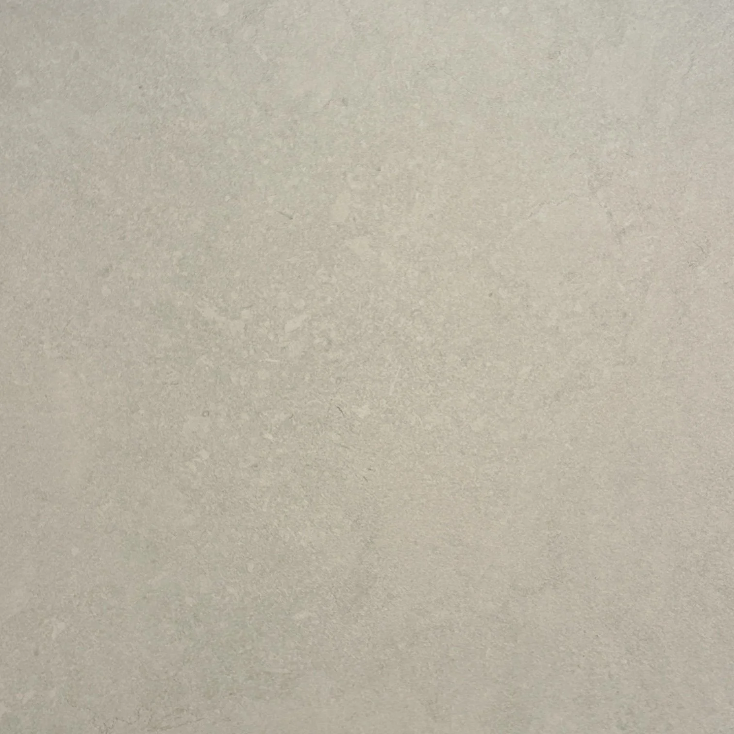 Close-up view of a textured beige or light grey surface.