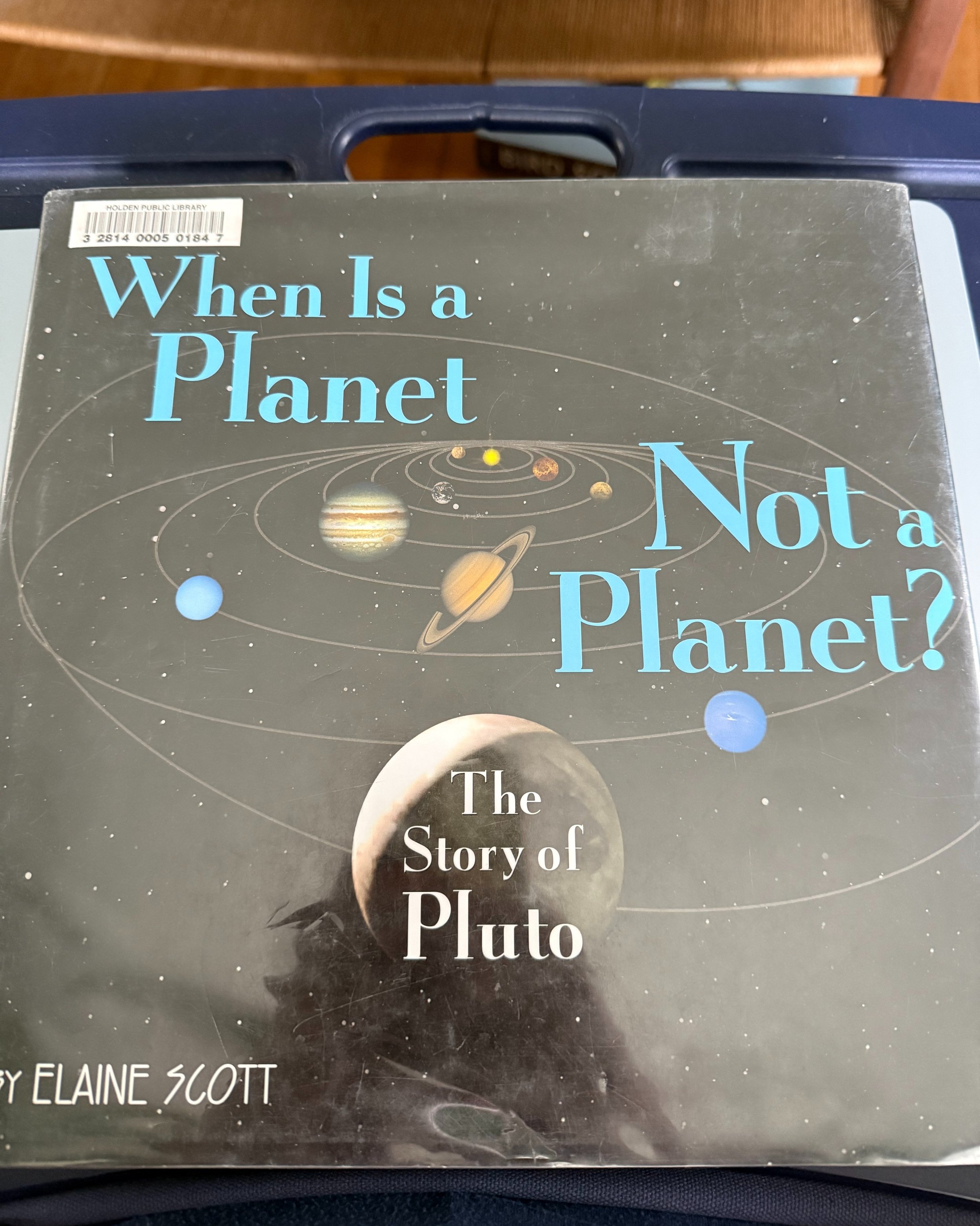 WHEN IS A PLANET NOT A PLANET by Elaine Scott. This is a great book about the history of discovering how our solar system works, and why some things are planets and some are not. Then it explains why Pluto does not fit into the planet category, and h