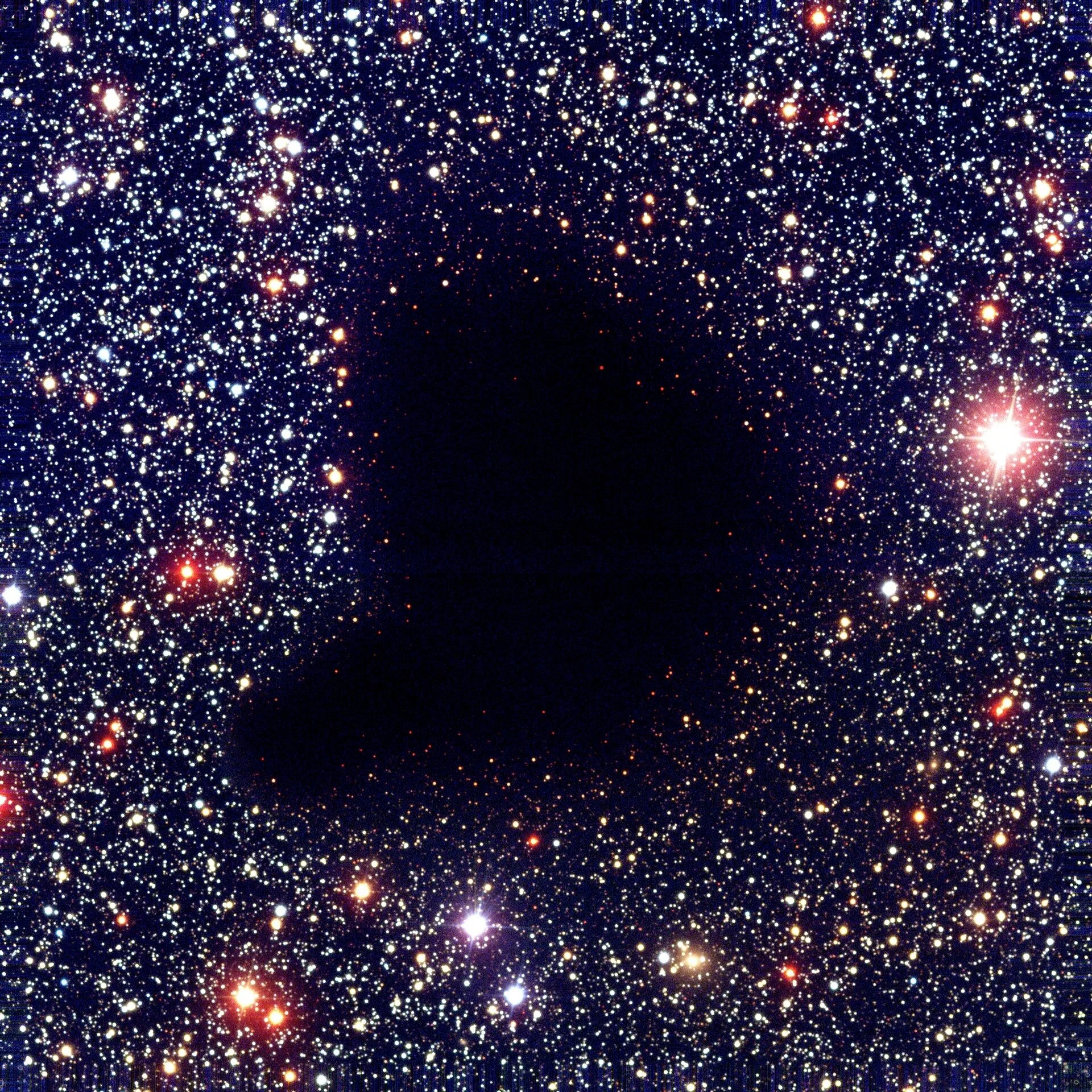 A void??? No, this is Barnard 68, a dark nebula inside our very own Milky Way galaxy, which is a collection of dense dust and gas that looks opaque with the human eye. It's about twice the mass of the sun and about a half lightyear across. Scientists