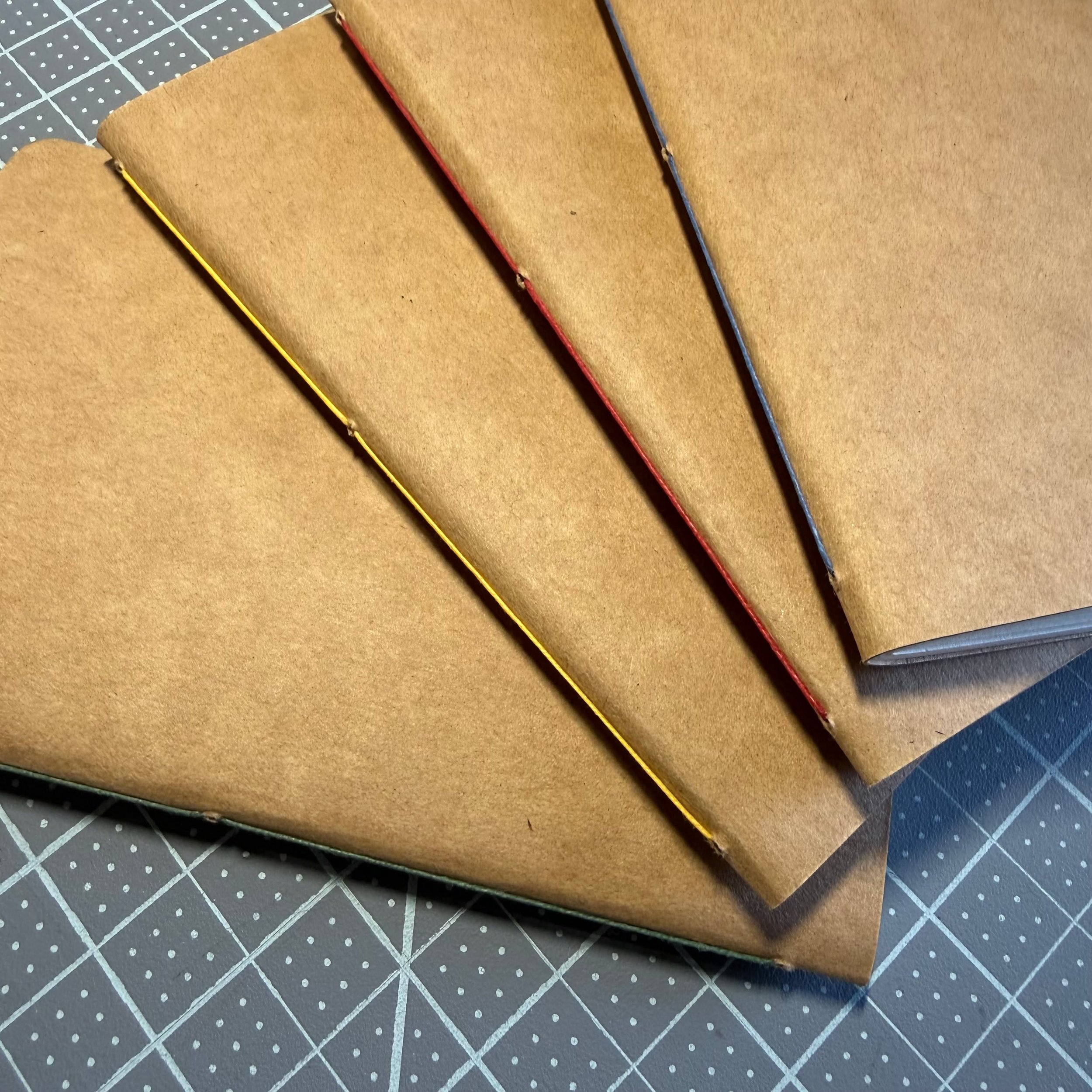 New kraft card covered pocket notebooks are in my shop. These are handmade by me, and just waiting for you to make them your own! Four colors of thread to choose from for now, more coming. They have nice thick dot grid paper inside that works awesome