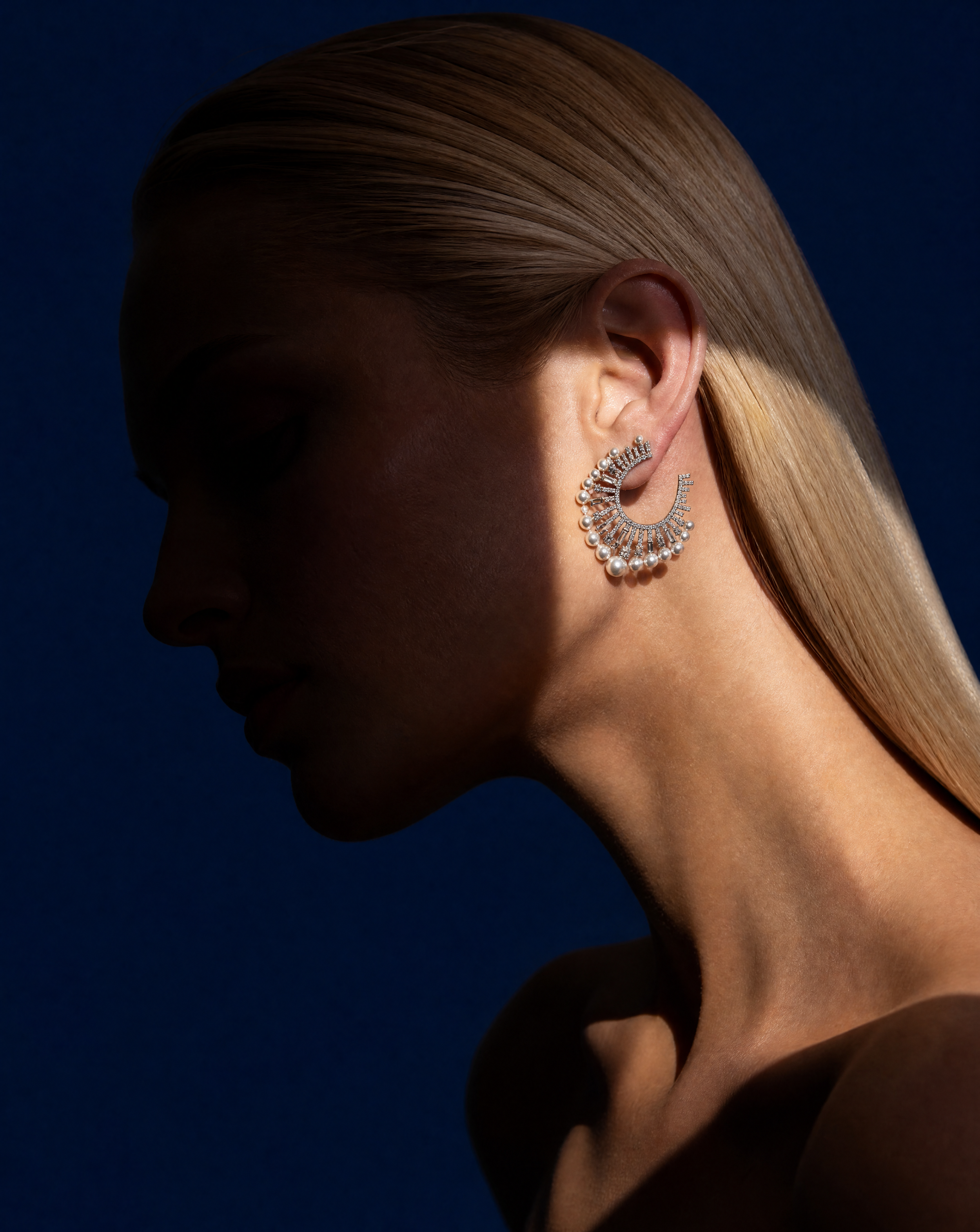 Generated with Kive.ai - Global rules (included in each prompt already) Ultra-photorealistic fashion editorial studio photo Blonde model_ face not clearly visible (shadow covers eyes upper face) Strong sunlight beam + hard shadow patter (1).png