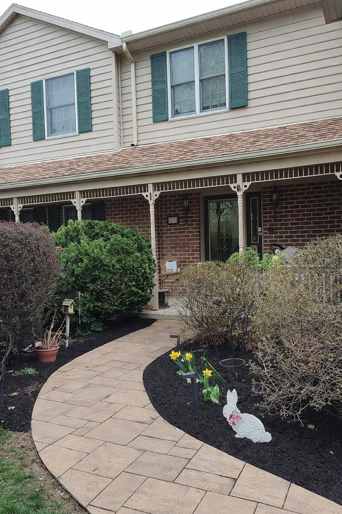 Clean front walkway with fresh mulch and trimmed landscaping after professional spring cleanup service in Central PA