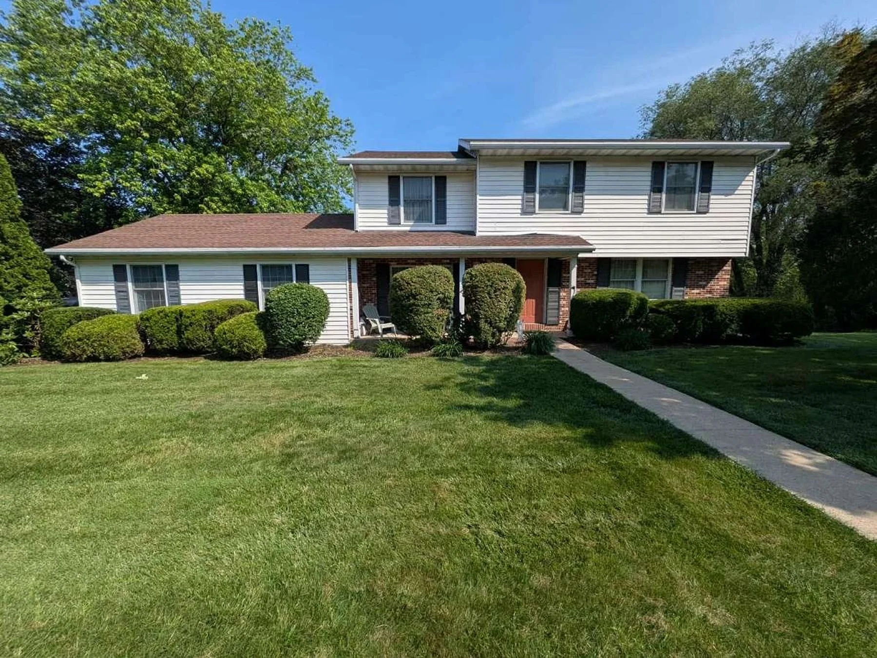 Freshly mowed front lawn with clean edging and maintained landscaping by professional lawn care service in Central Pennsylvania