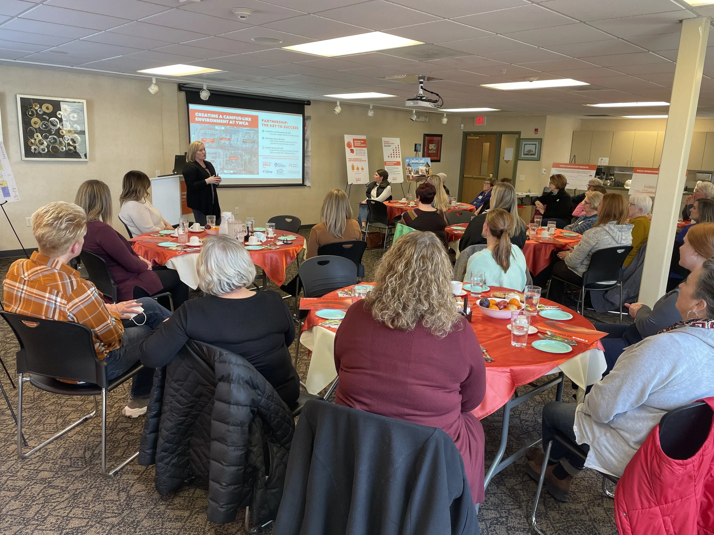 Group of women sitting around tables in community room
