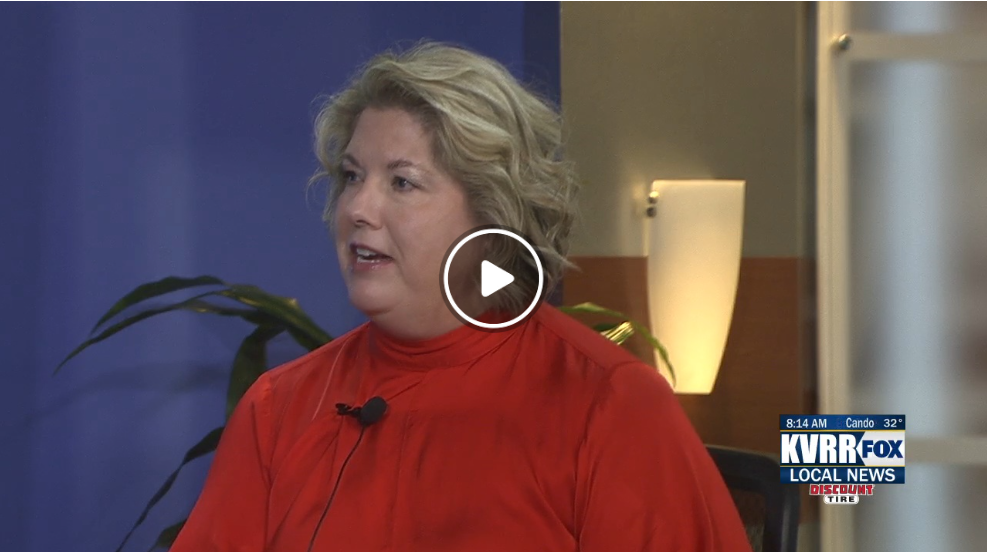woman wearing red and lavalier mic speaking