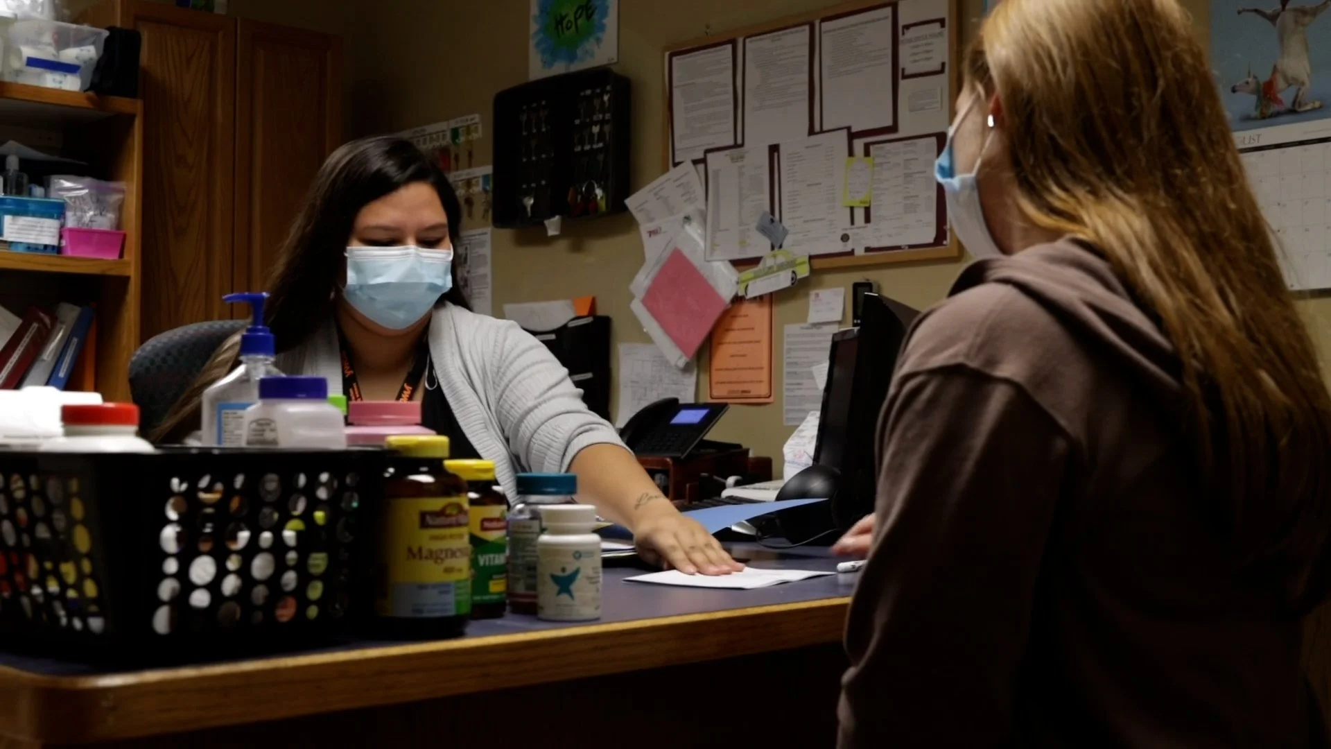 Two women in masks in YWCA's intake office