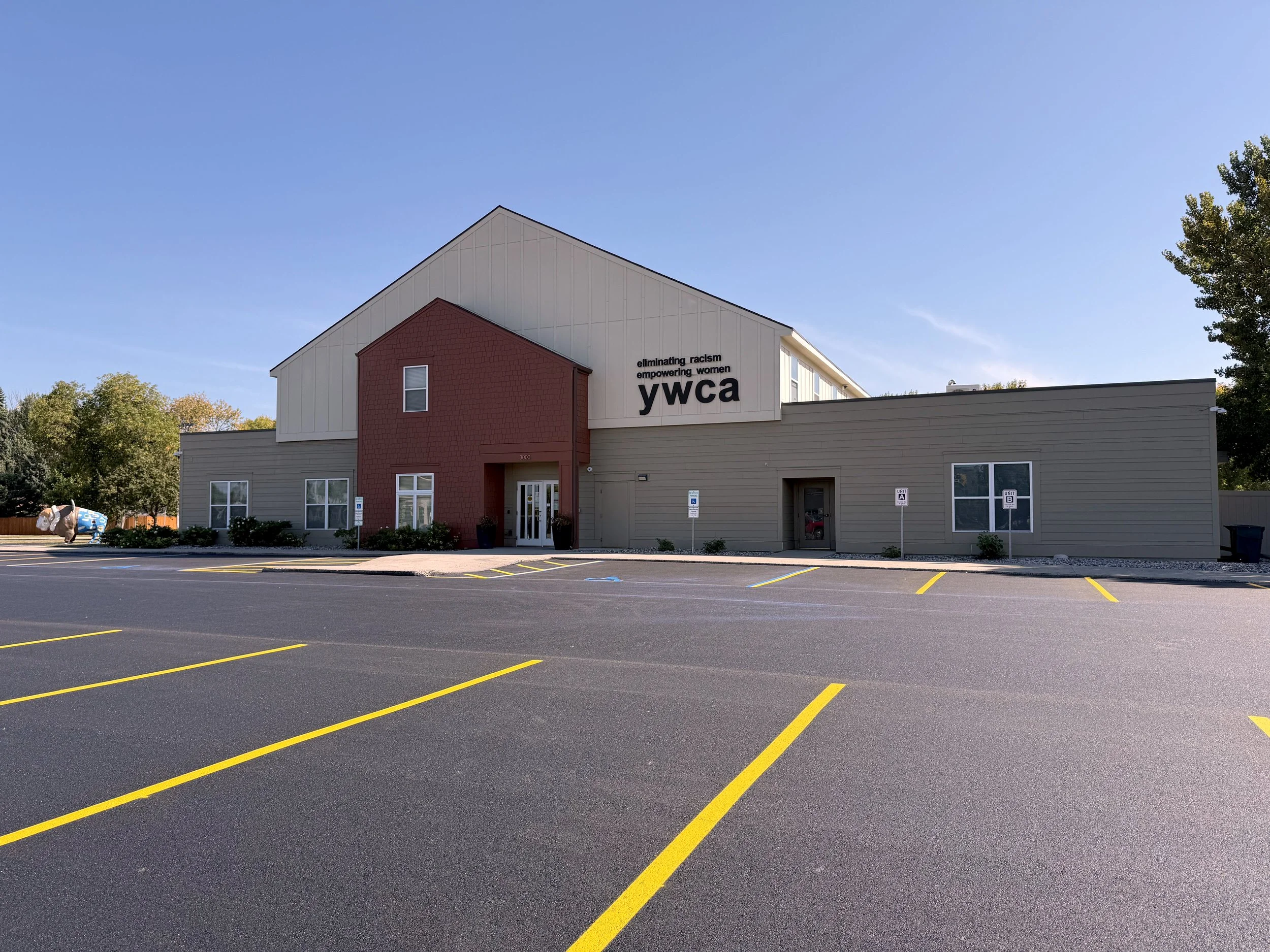 Exterior of tan building with freshly striped parking lot