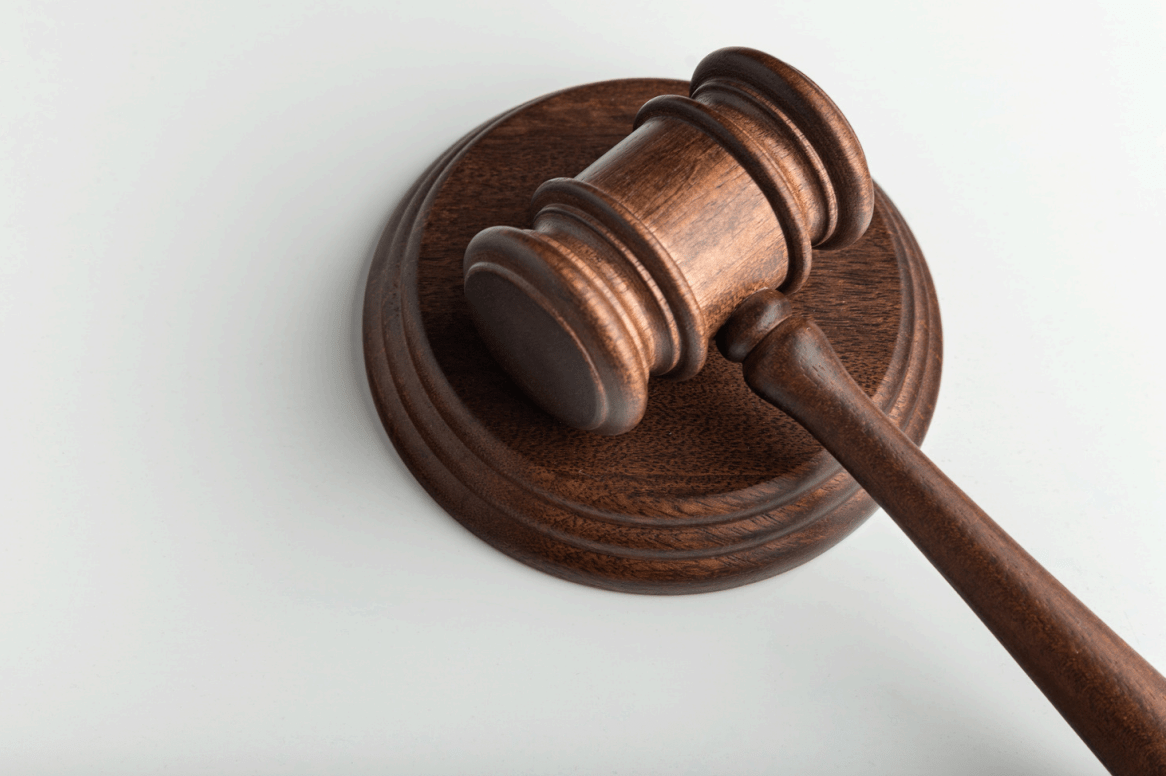 Dark brown wooden gavel and round sound block.