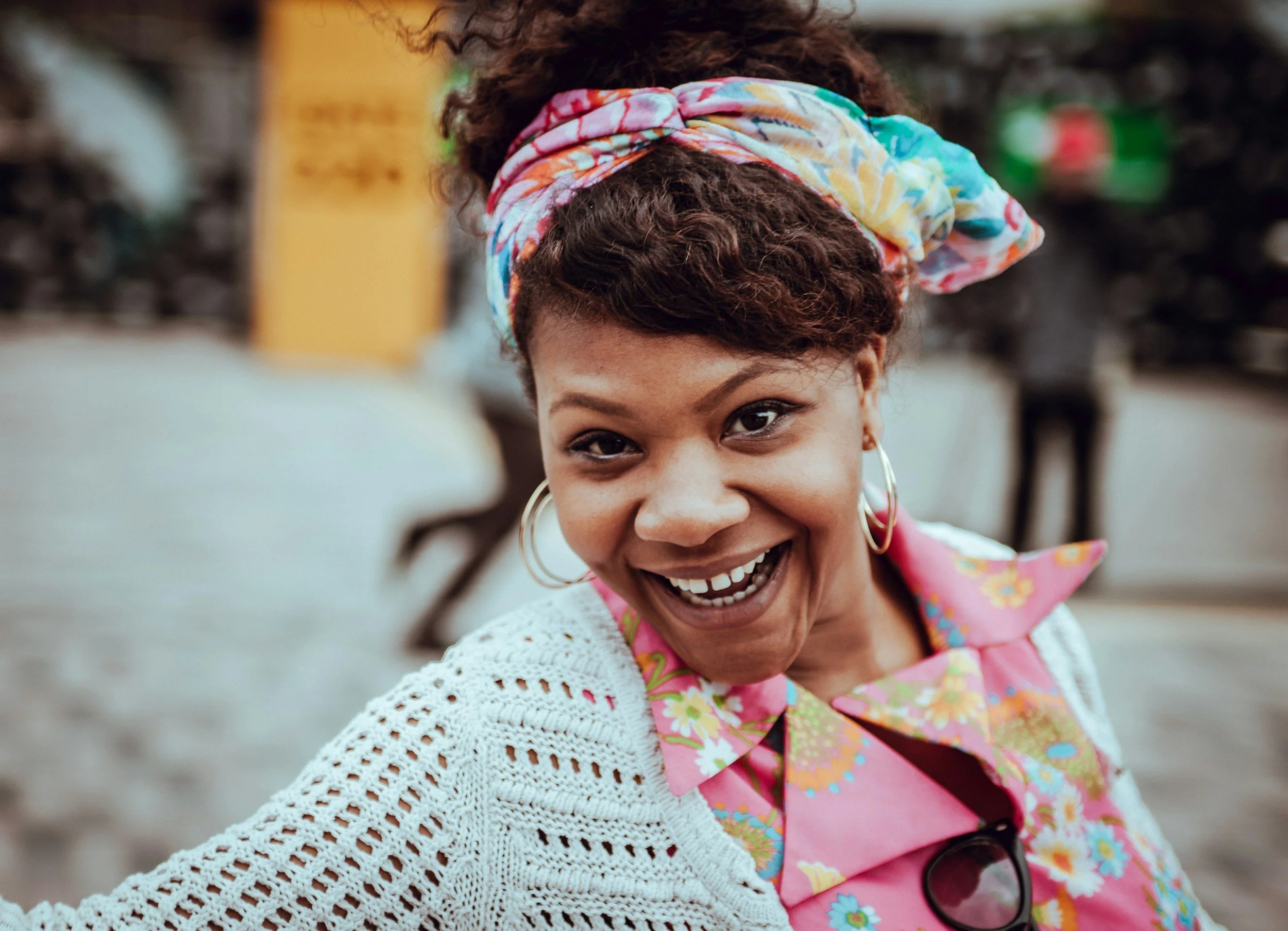 Image of a smiling African American woman standing outside. Discover how you can control your emotions and how somatic therapy in Pasadena, CA can help you with healing. | Rezak Therapy