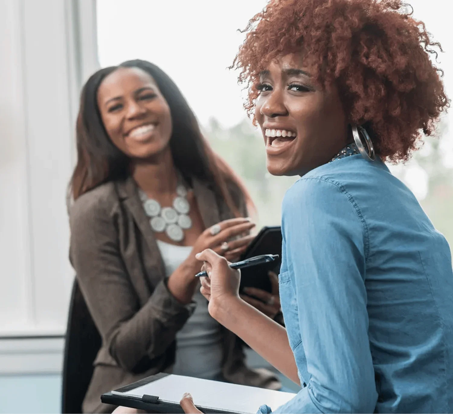 two women discussing business growth and program opportunities