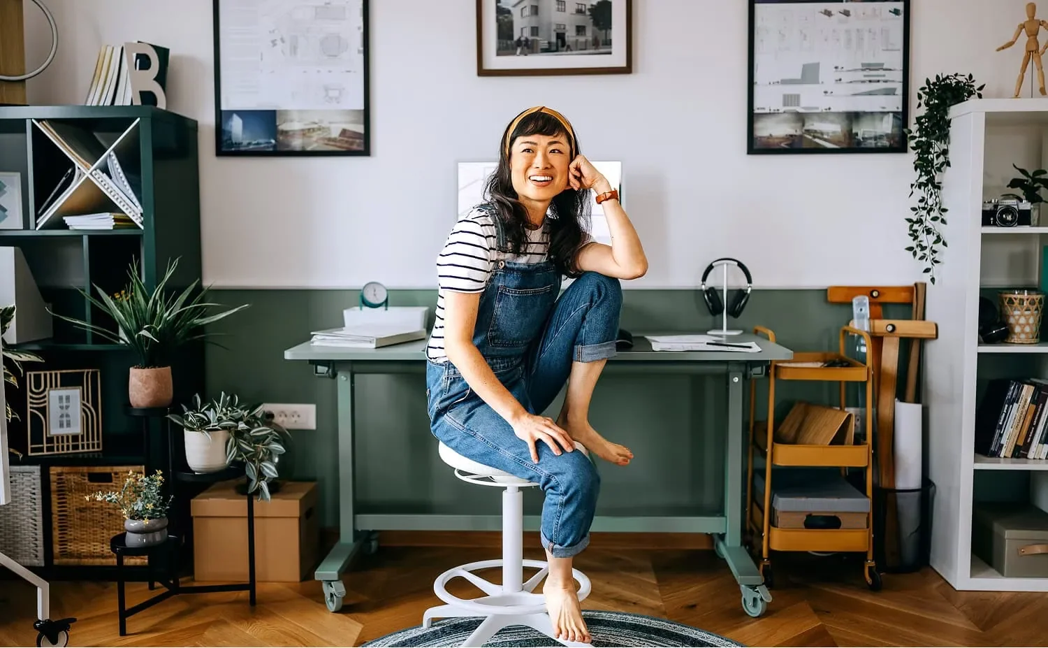 woman in coveralls sitting beside desk representing rural business work