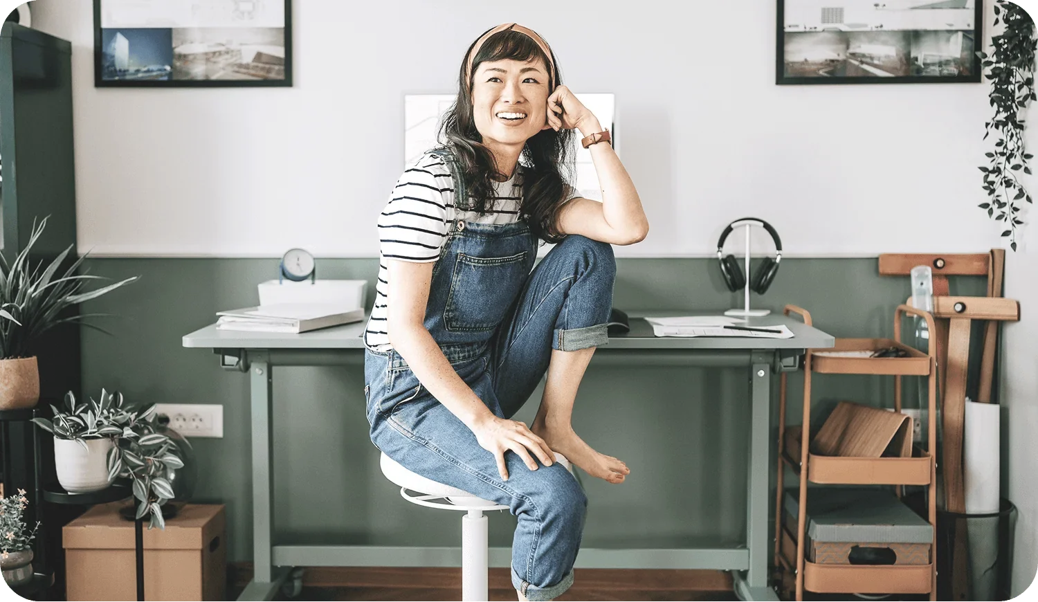 Alberta women entrepreneurs emerging founder working at green desk in coveralls building her business