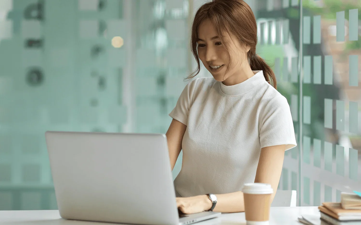 woman typing on laptop participating in upcoming business learning program