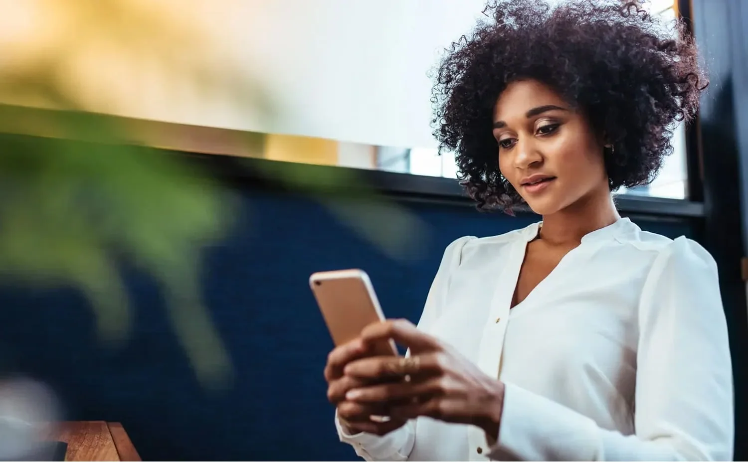 woman using cellphone accessing business support in northern Alberta