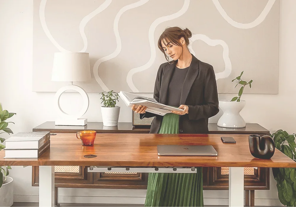 woman reviewing documents at desk managing established business operations