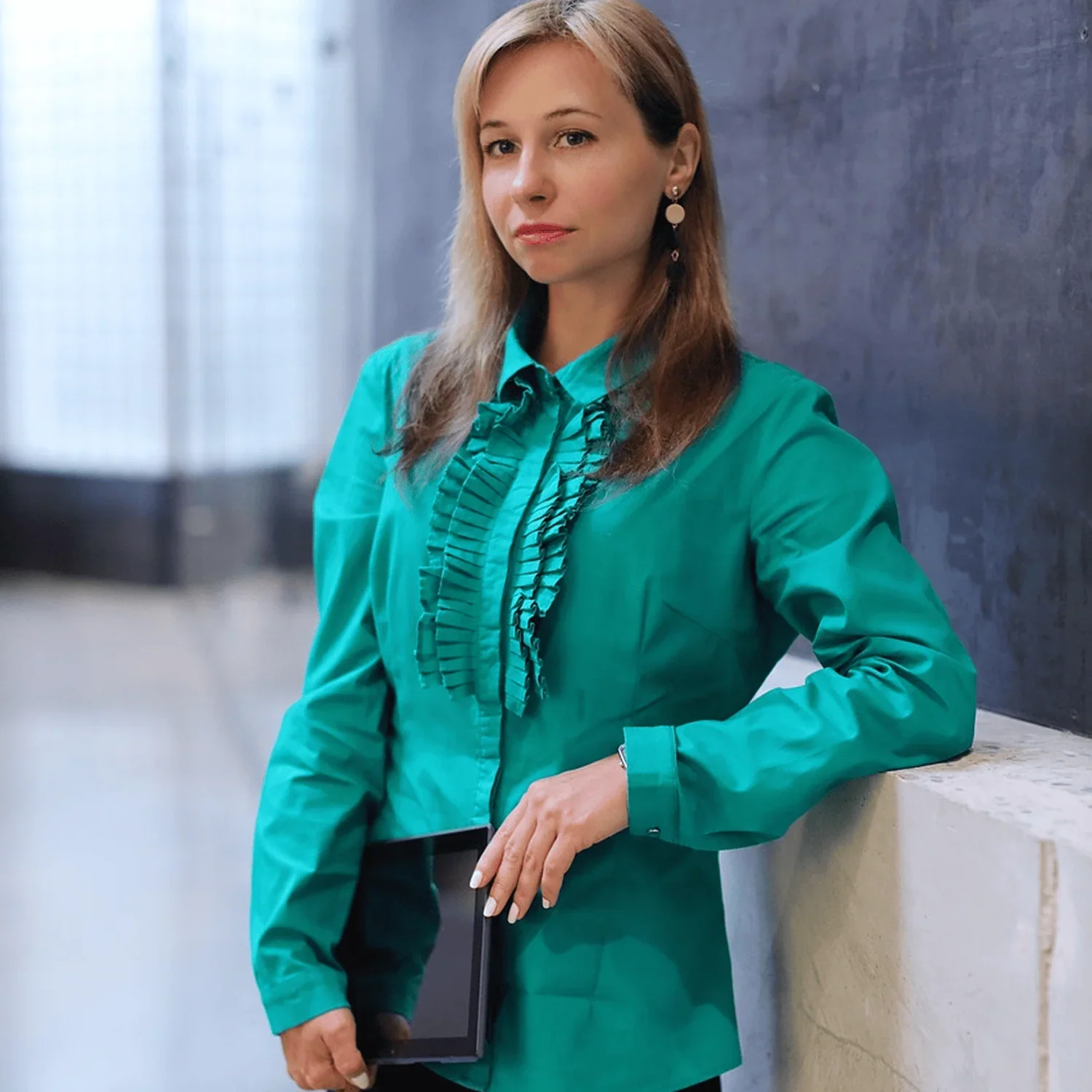woman in green blouse posing for portrait representing emerging entrepreneur