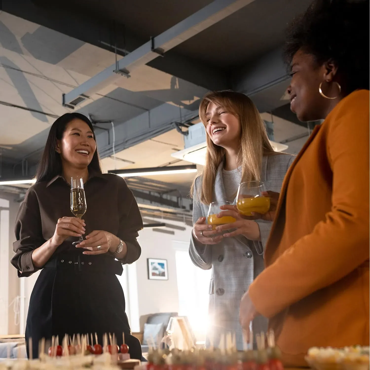women holding drinks and talking during networking event for women entrepreneurs