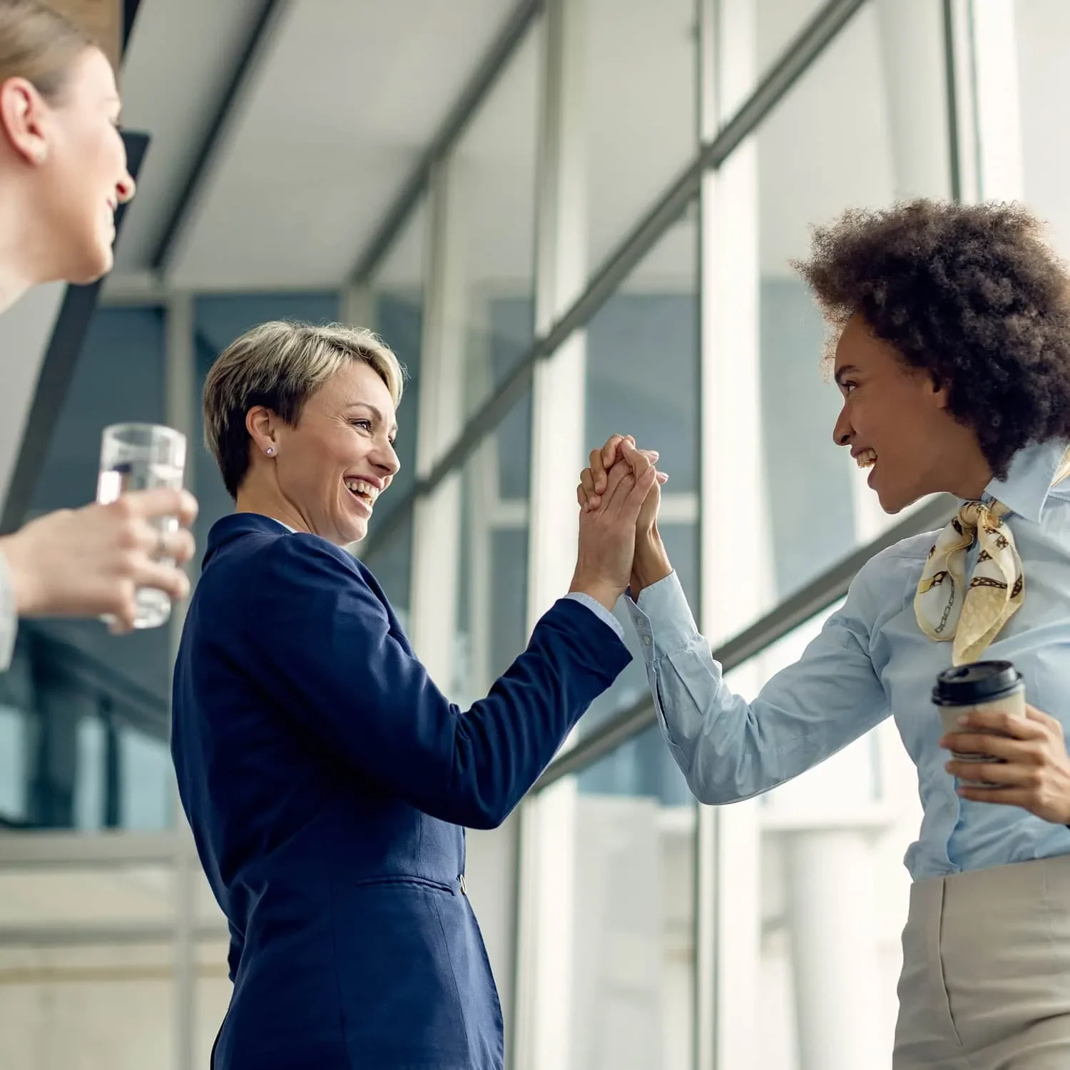 two women celebrating with high five during AWE awards