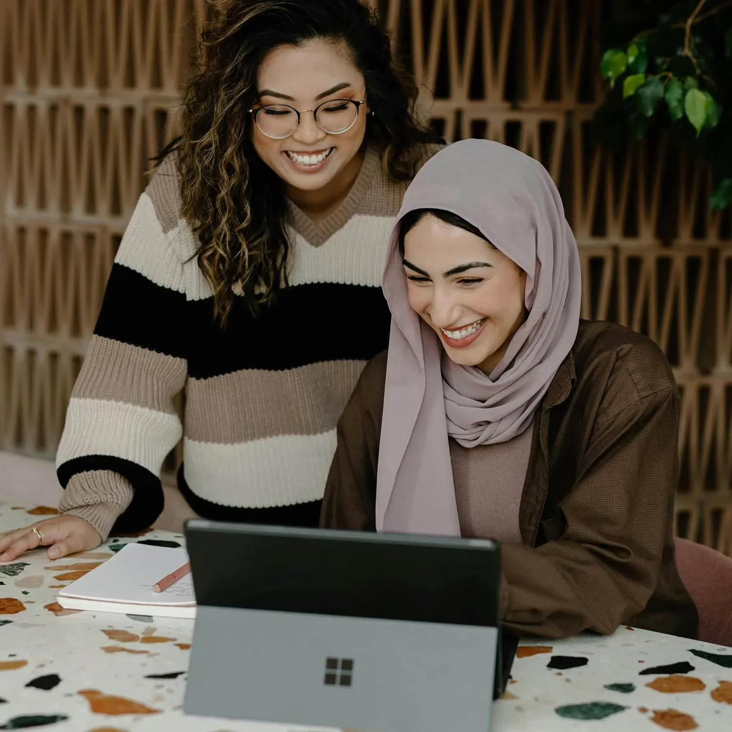 two women reviewing laptop together as partners supporting business growth
