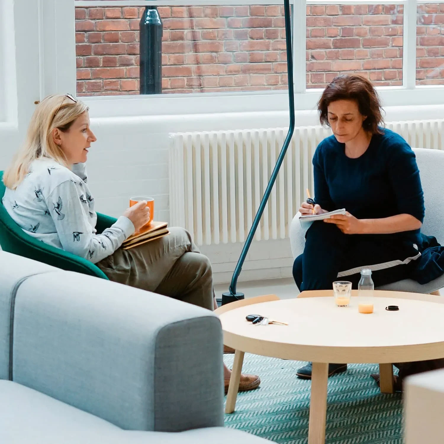 Two women in conversation discussing AWE board of director recruitment