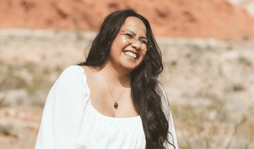 woman outdoors smiling representing commitment to next steps in business planning