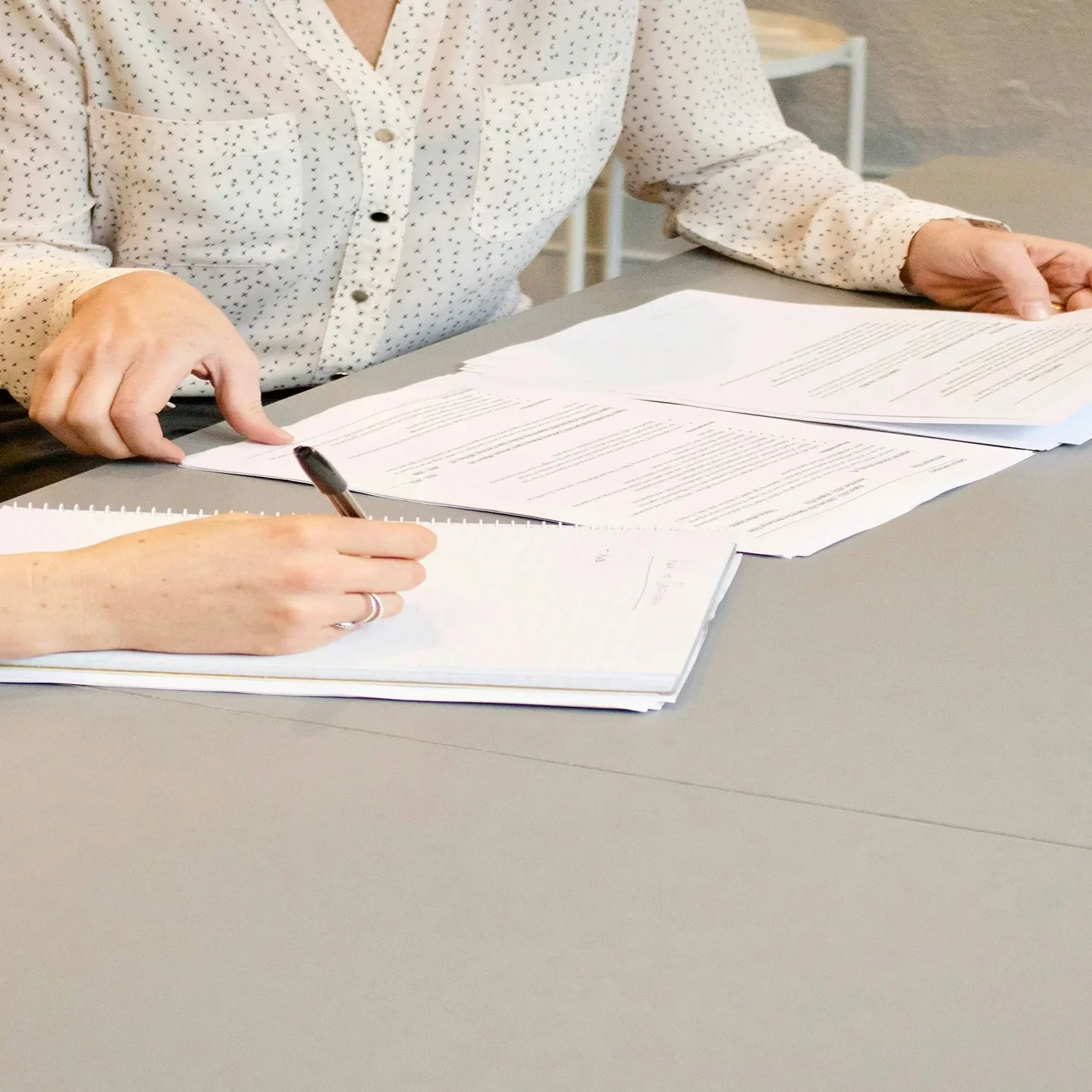 close-up of two people reviewing documents for business financing application