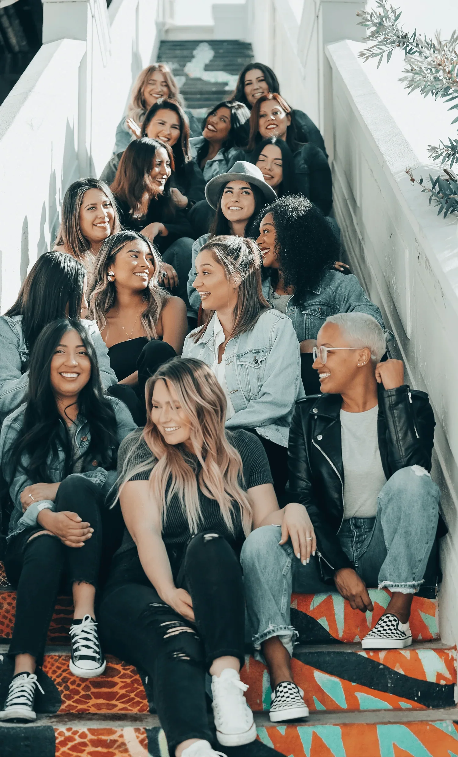 group of women seated on stairs engaging in peer leadership discussion