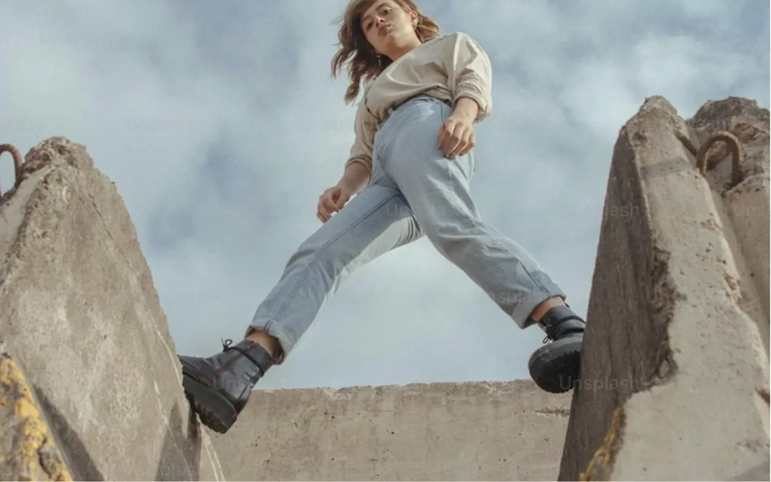 woman walking across large gap representing advanced business program for growth