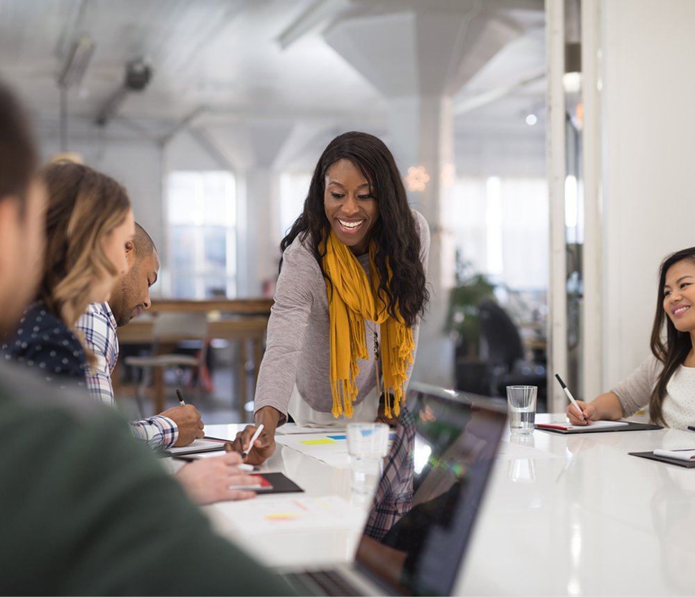 woman in meeting pointing something out during business discussion