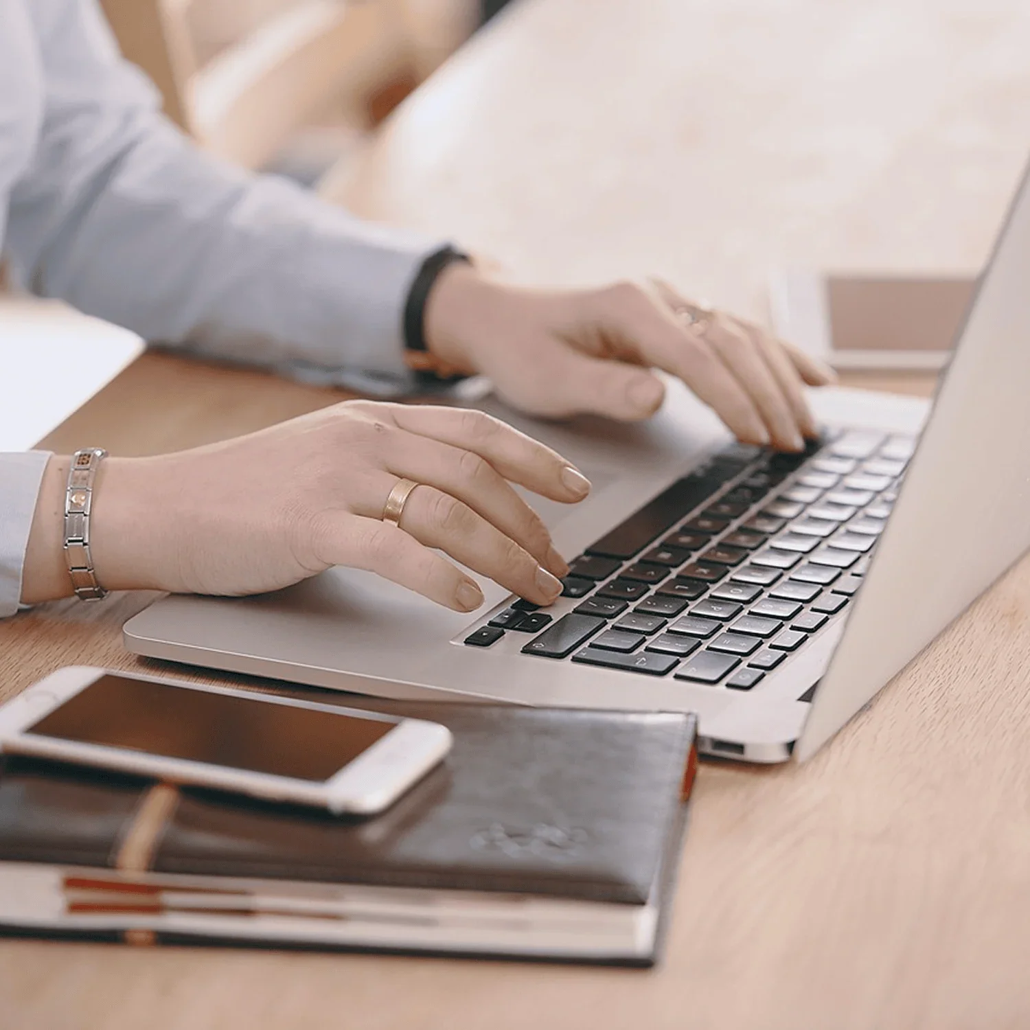 hands typing on laptop preparing for business financing decisions