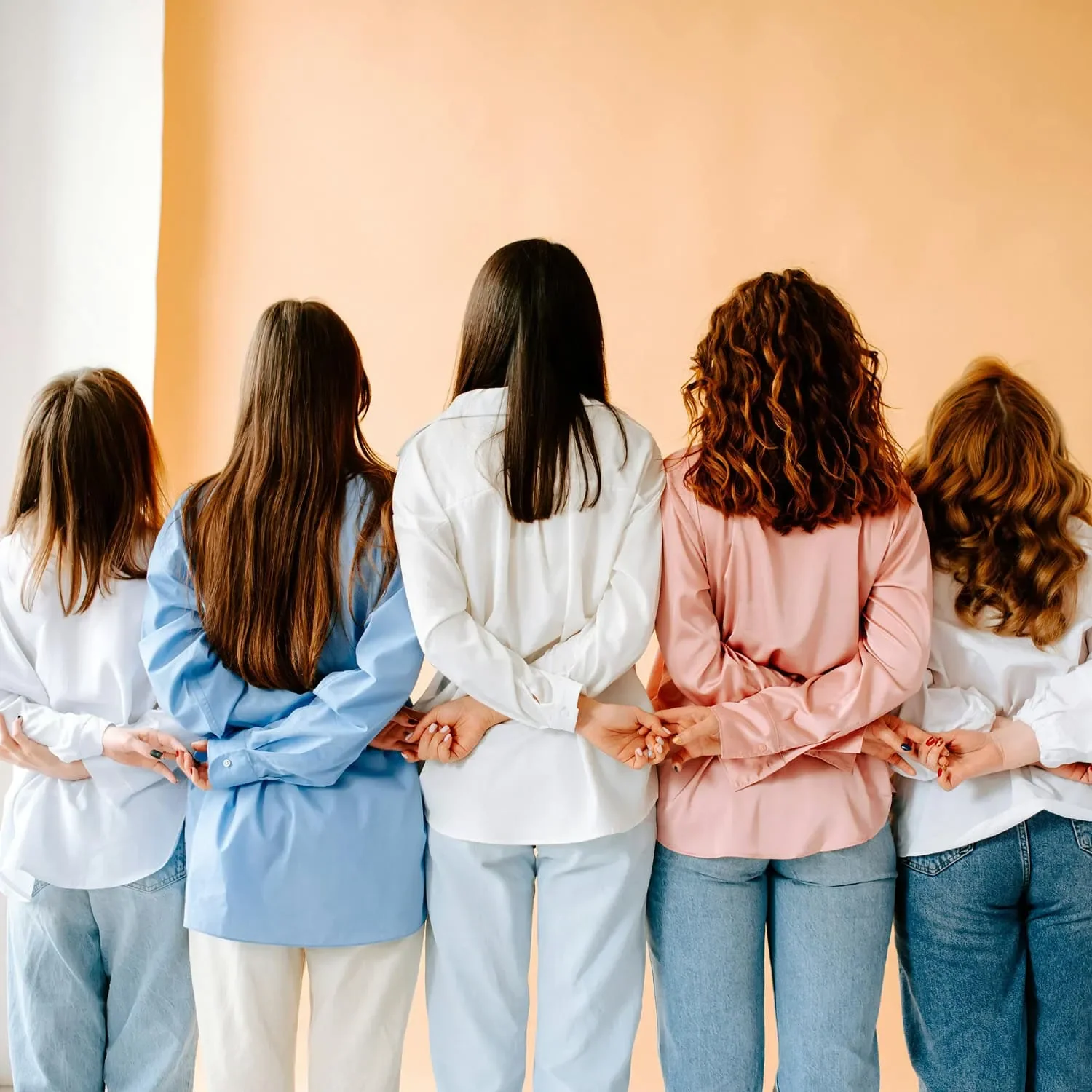 group of women holding hands representing connection and accountability