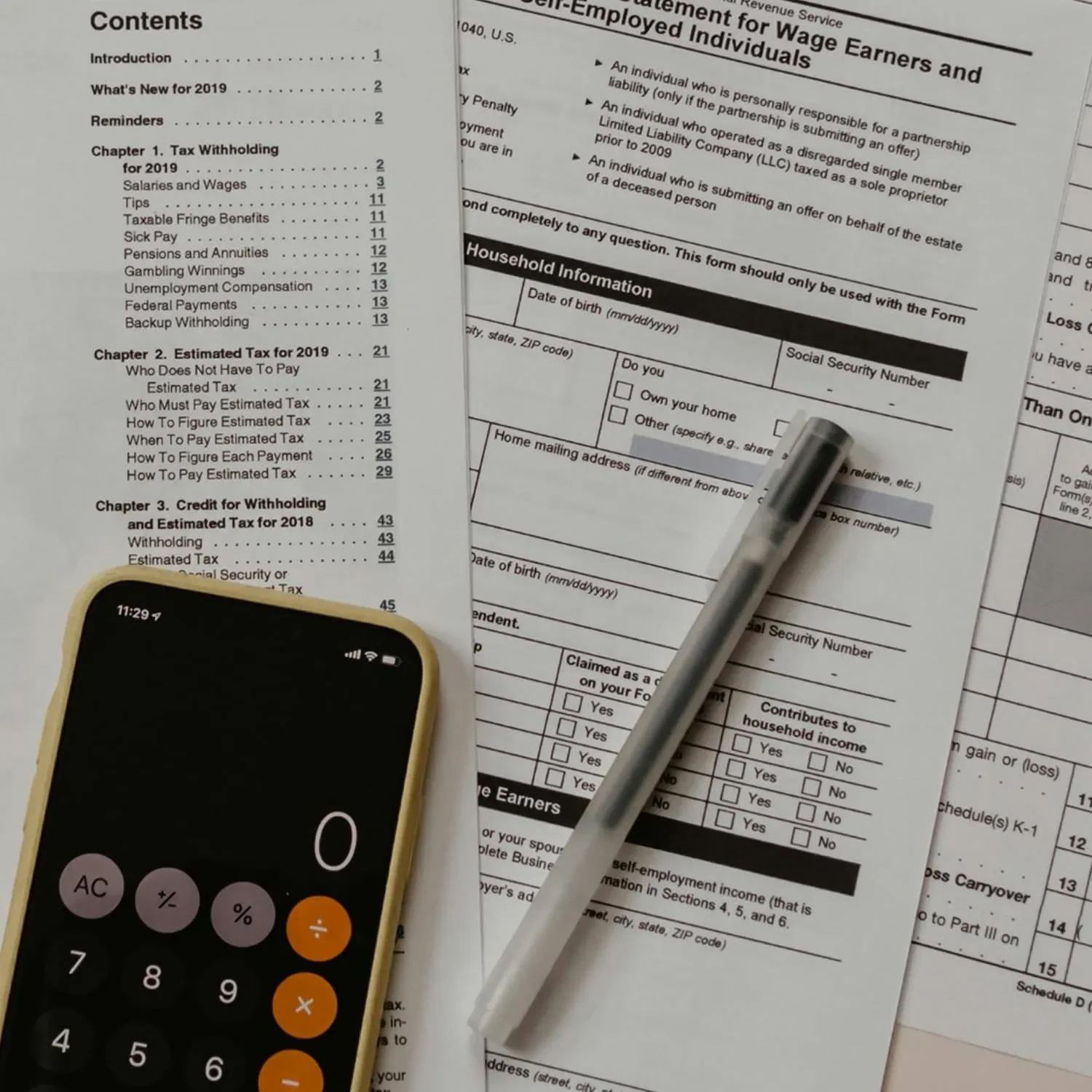 calculator on phone with pen and paper for business financing planning