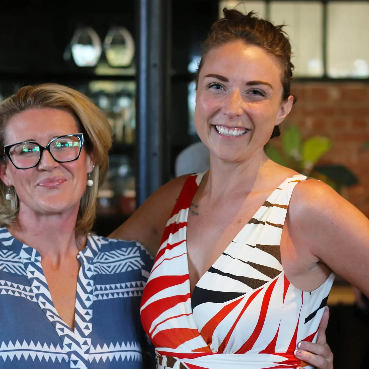 2 business women posing for photo during the AWE summit?