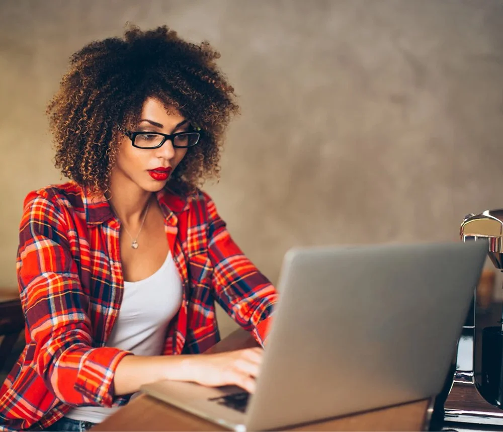 woman typing on laptop accessing business support resources