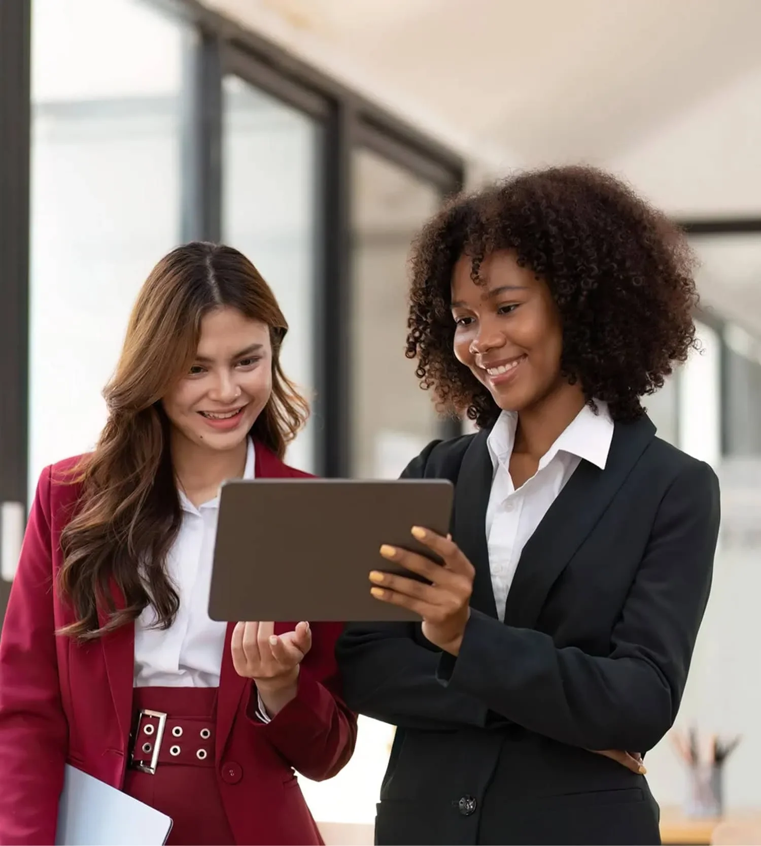 two women reviewing funding options together on tablet