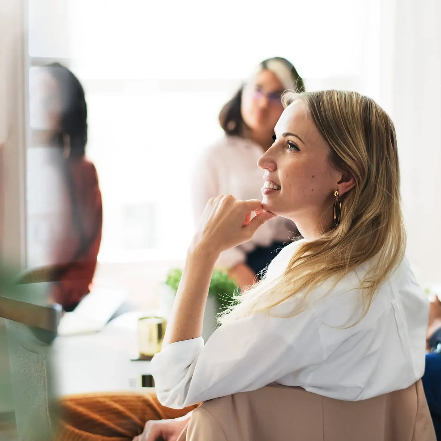 woman listening at boardroom table during leadership meeting