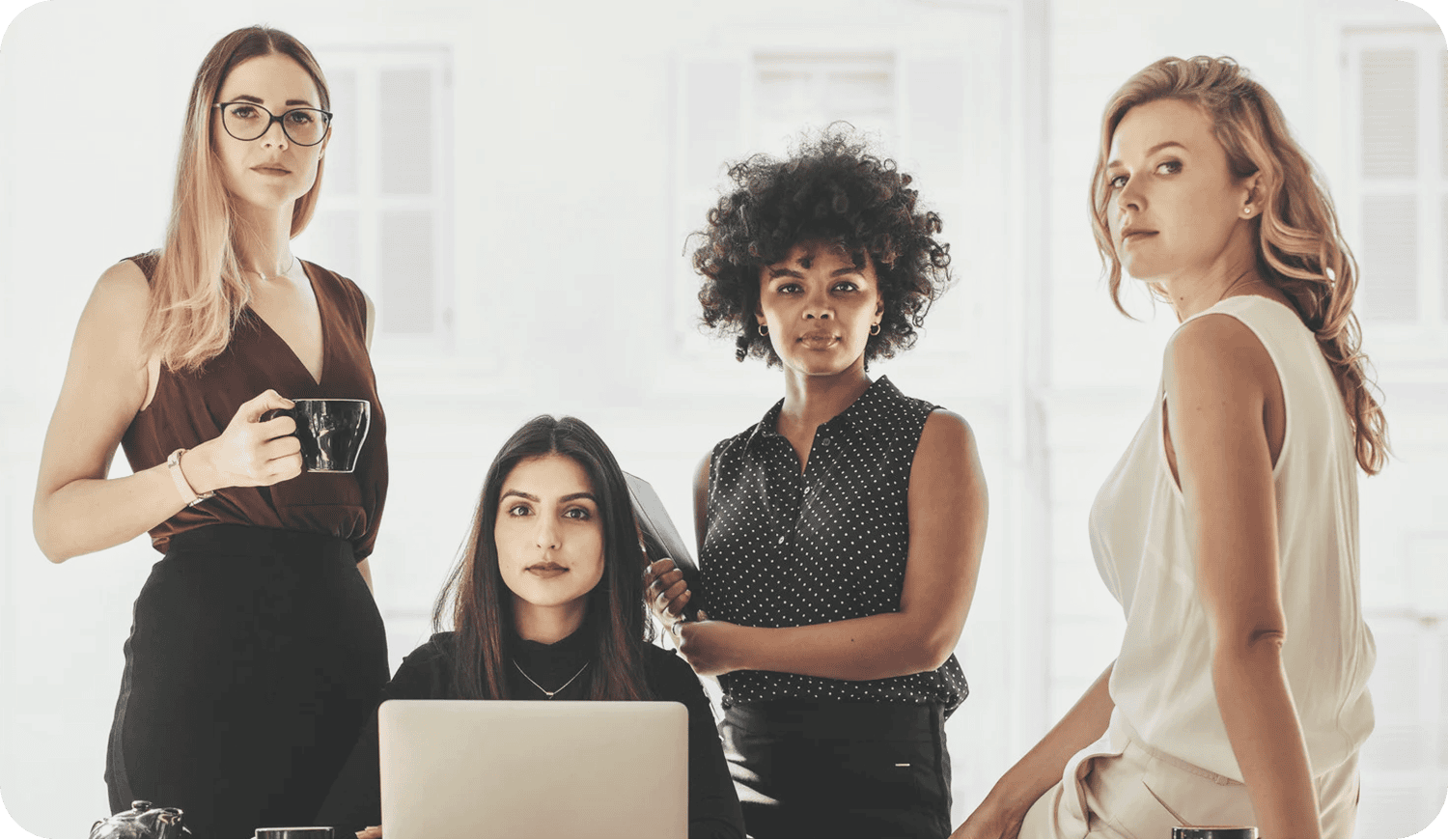 Alberta women entrepreneurs established leaders collaborating at desk and looking at camera
