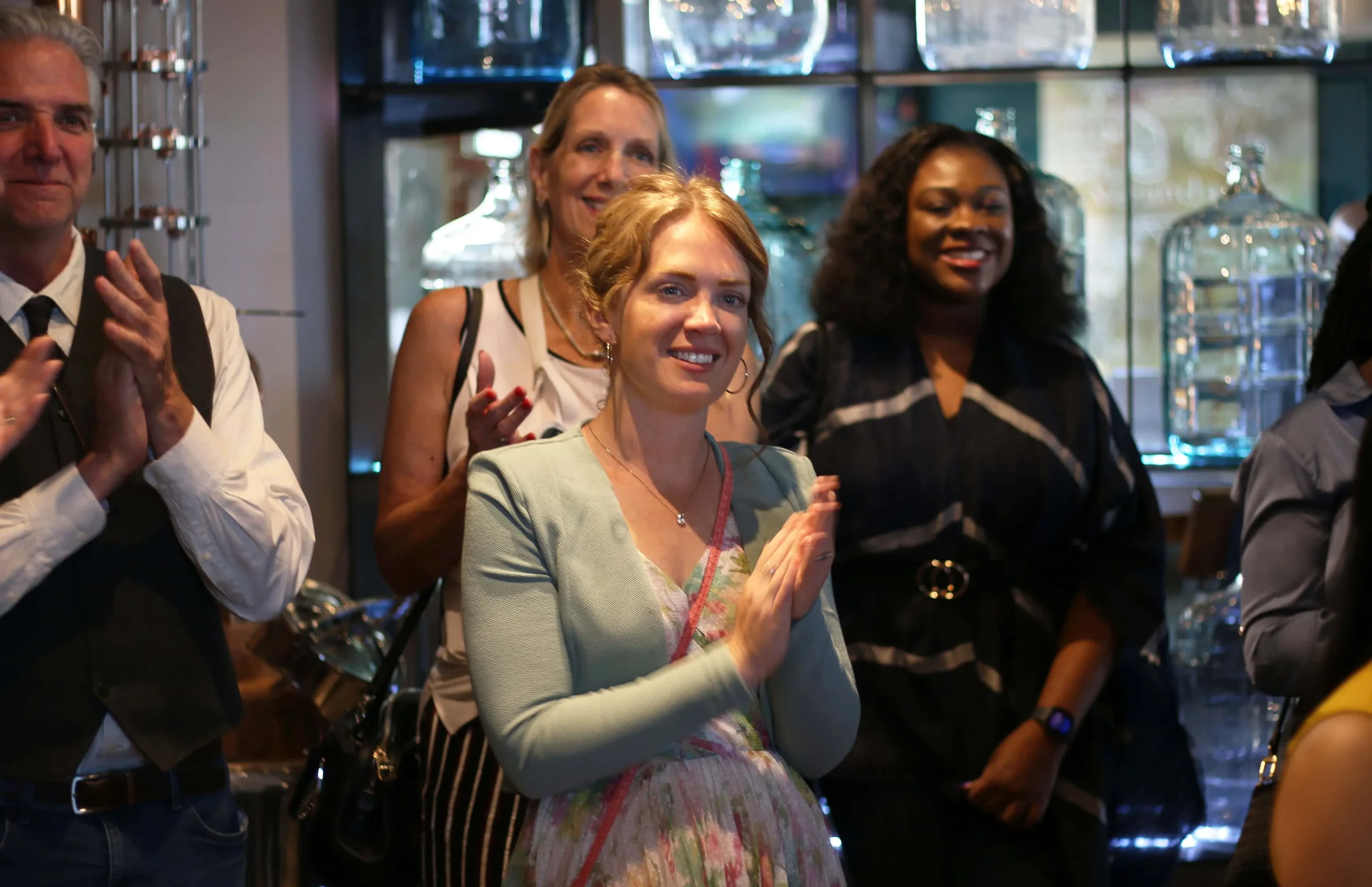 women clapping during AWE 30 year celebration event