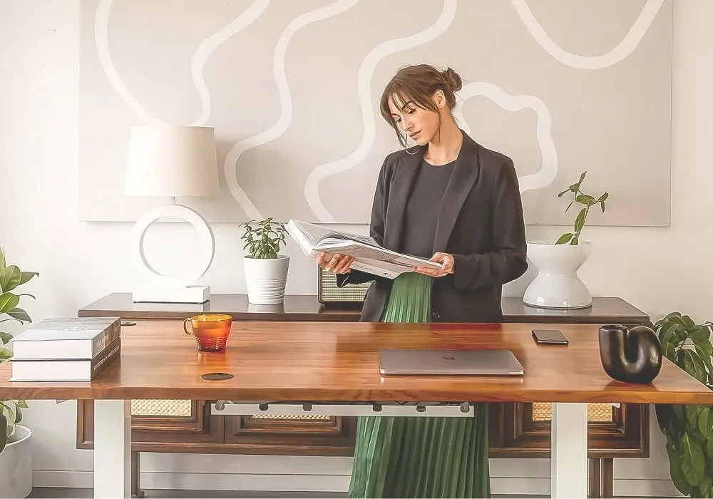 woman standing at desk working on early stage business planning