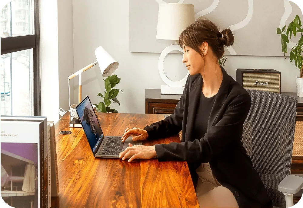 Business woman working behind laptop reviewing finances