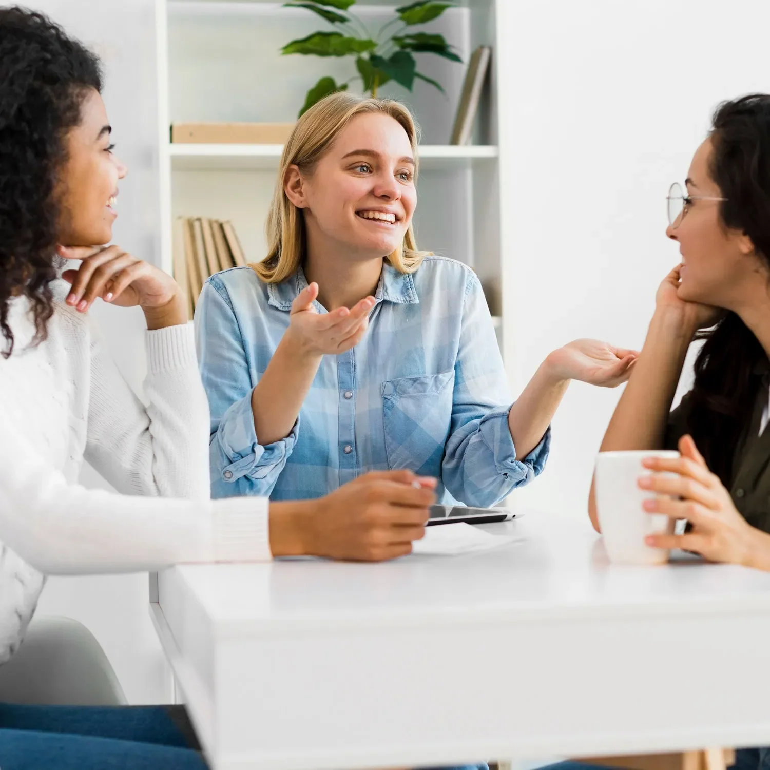 women facing each other discussing business decisions