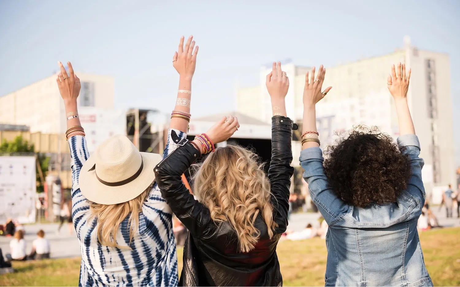 three women raising their arms together representing staying connected to community event
