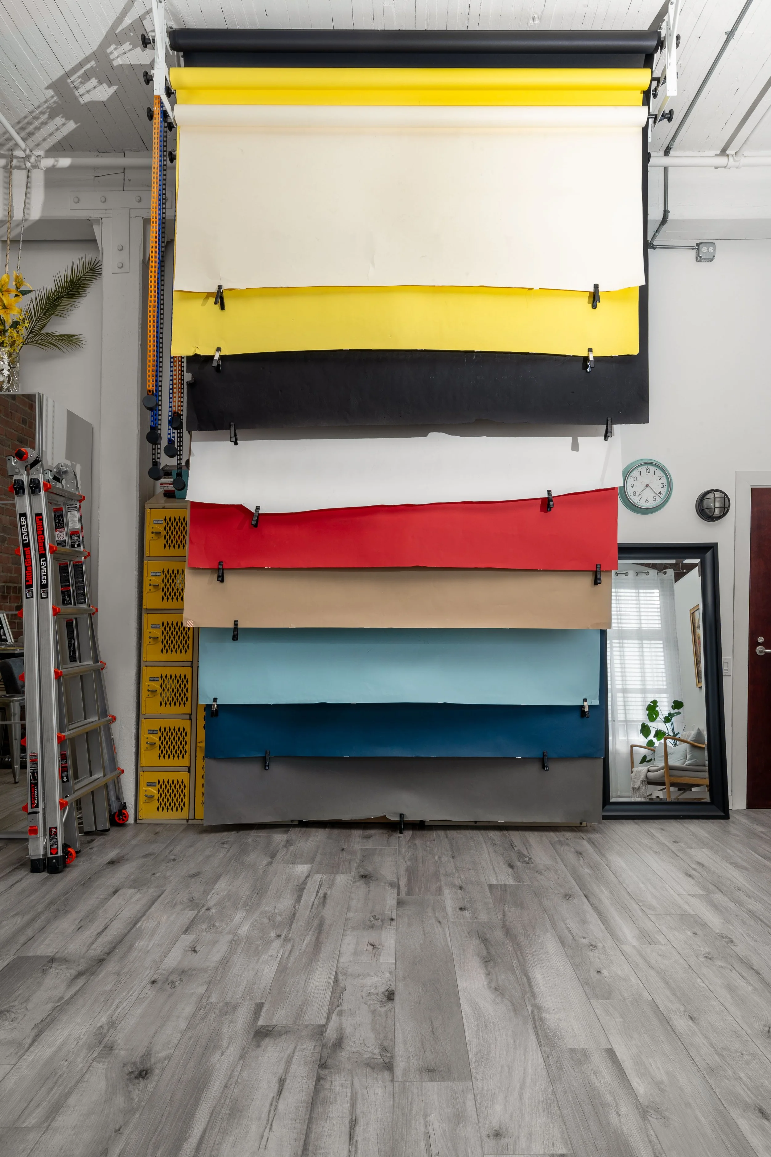 Colorful seamless backdrops hanging vertically from the ceiling at the Portrait Playdate headshot and portrait photography studio in Seattle, WA.